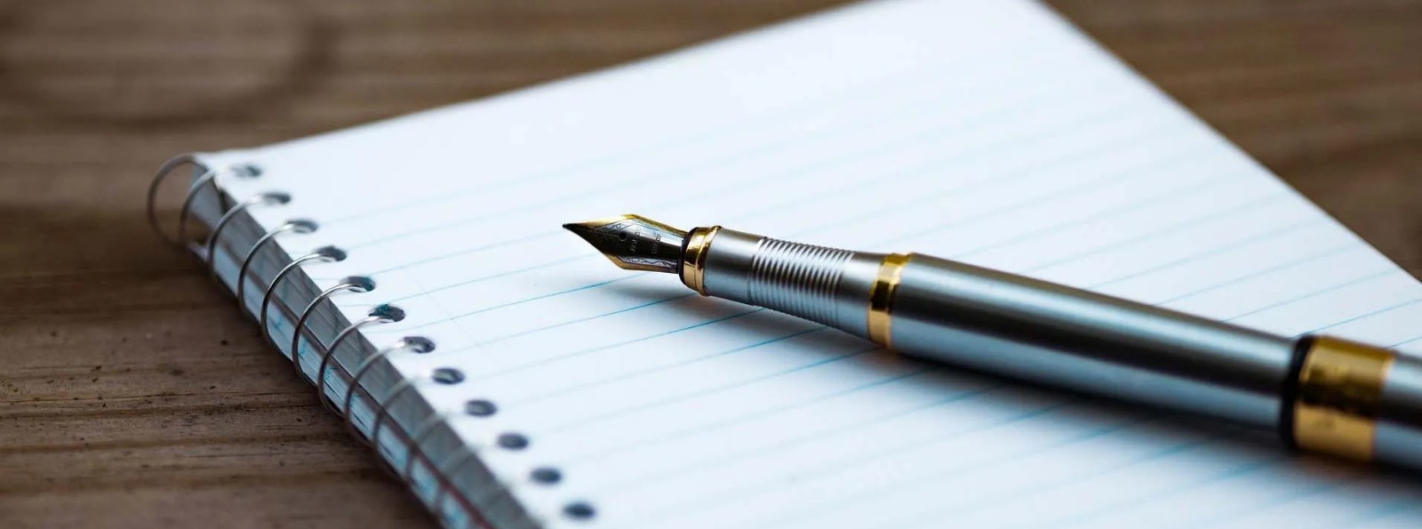 a fountain pen on a writing pad