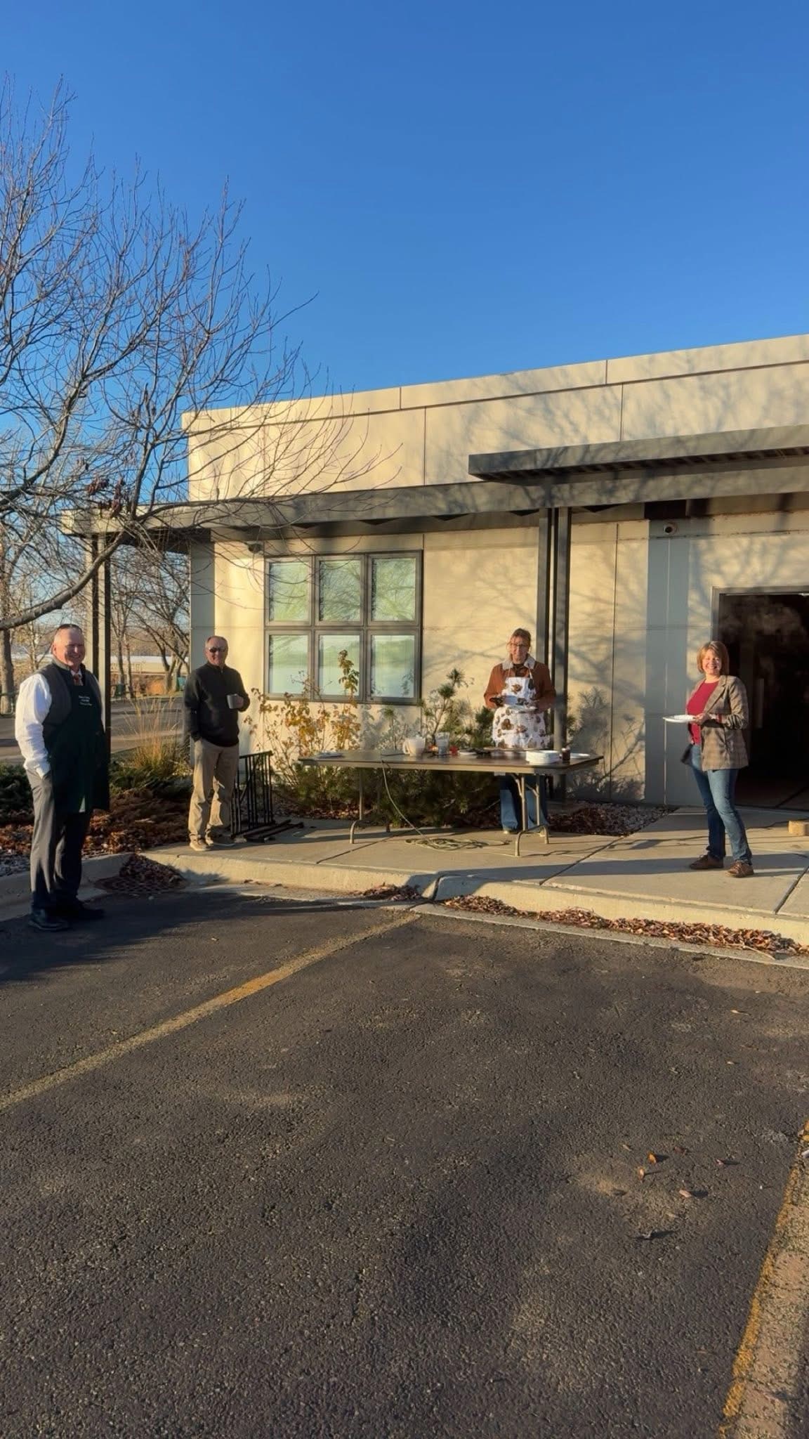 Bank employees enjoying pancakes outside of the Bank