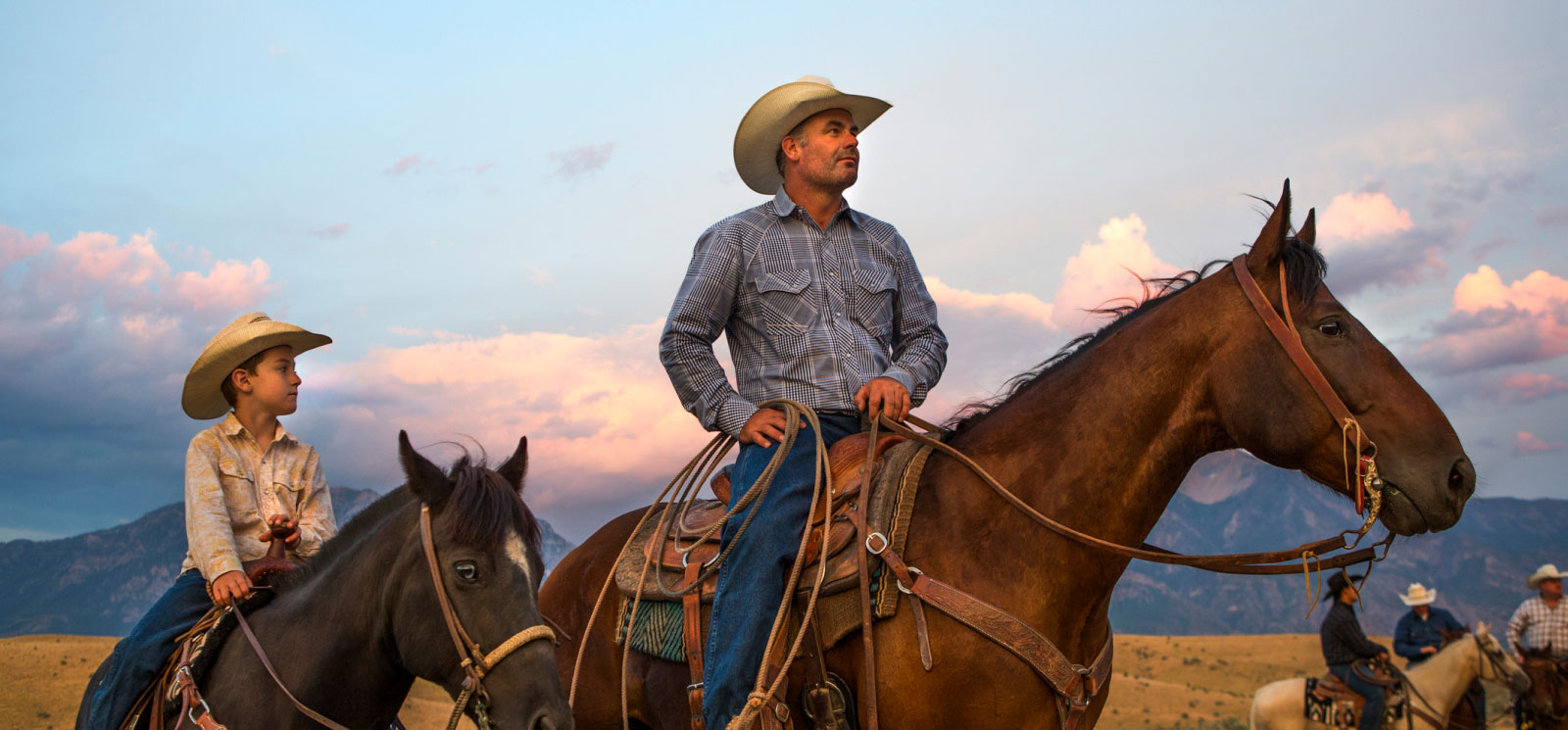 man and boy on horseback